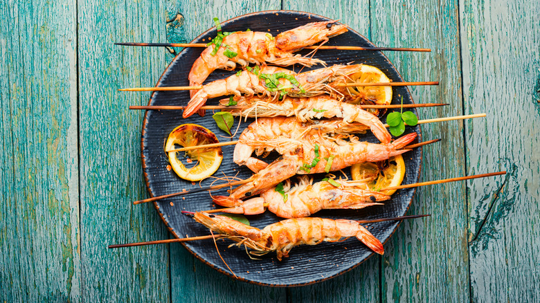 Grilled langoustines skewers green wood