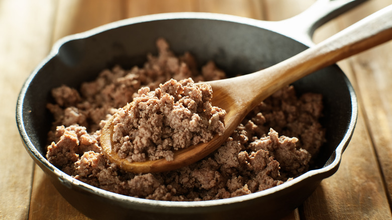 scooping ground beef from skillet