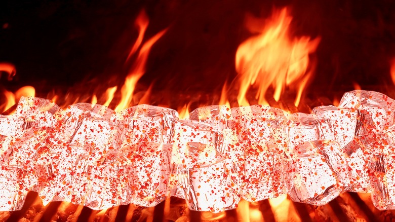 Seasoned ice cubes over a flaming grill 
