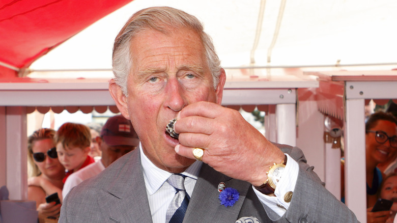 King Charles III eating oyster