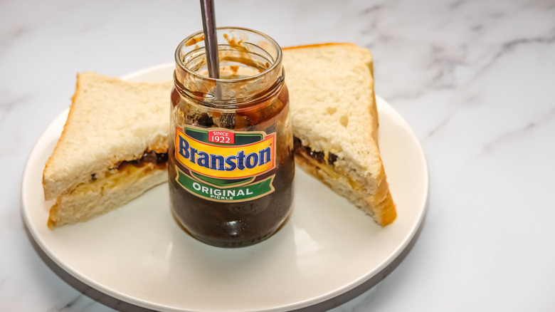Jar of Branston pickle between two half sandwiches