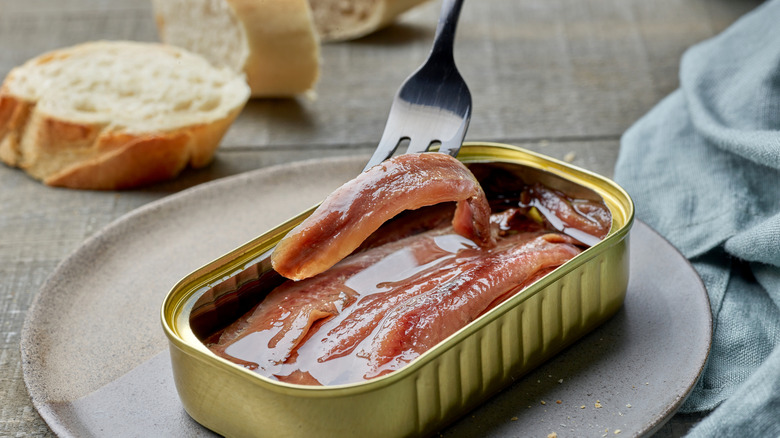 Open canned pink-fleshed anchovies