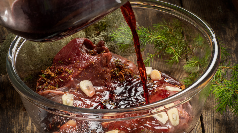 pouring marinade over meat 