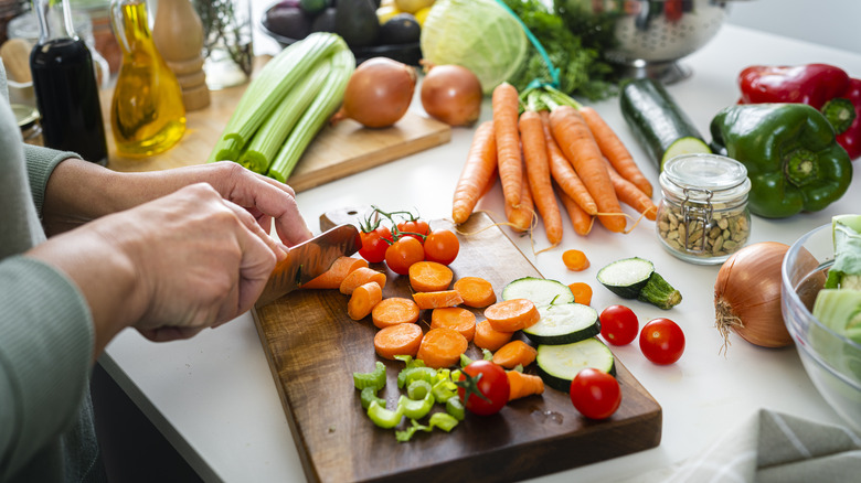 Woman chopping vegetables  on the counter