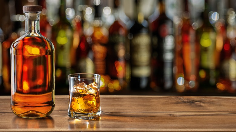 bottle of whiskey poured at a bar 