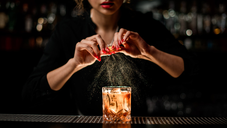 bartender crafting old fashioned