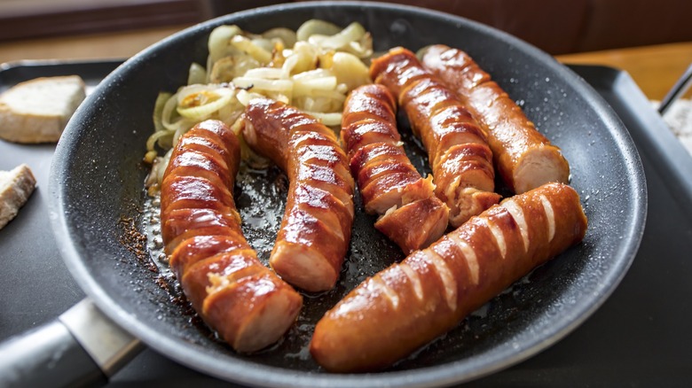 Polish kielbasa cooking in a pan