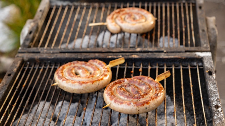 Bratwurst cooking on a grill