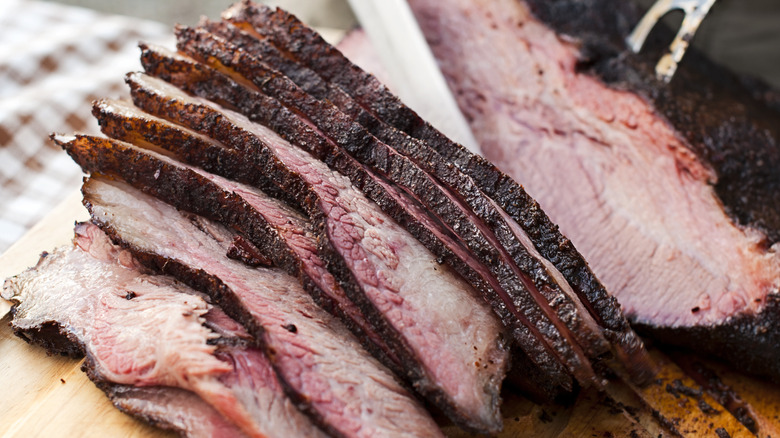 Sliced, smoked beef brisket on a cutting board