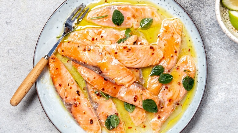 Top-down view of plated salmon crudo and garnishes