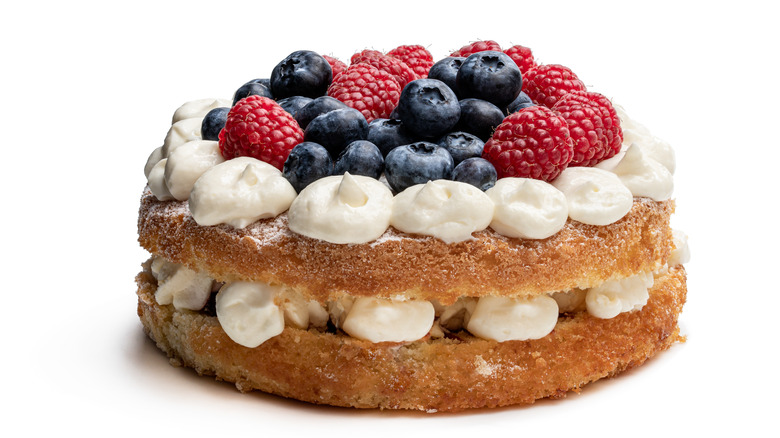 Sponge cake layered with whipped cream and berries