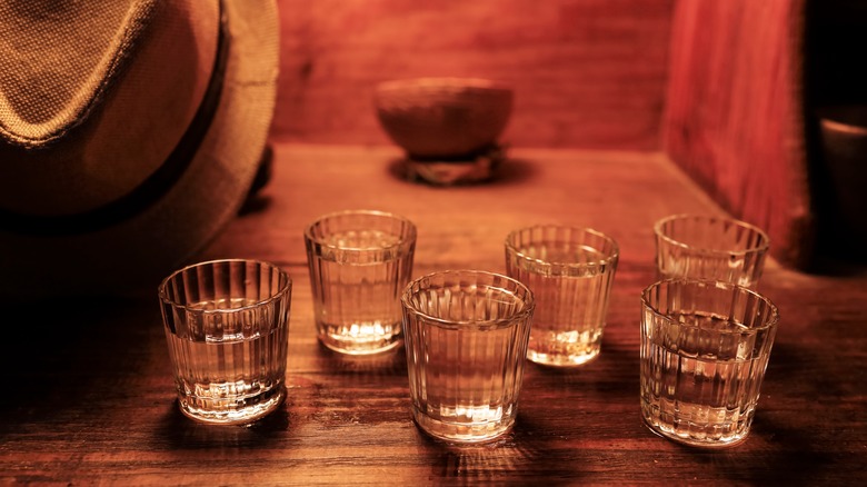 Glasses of mezcal in dim light