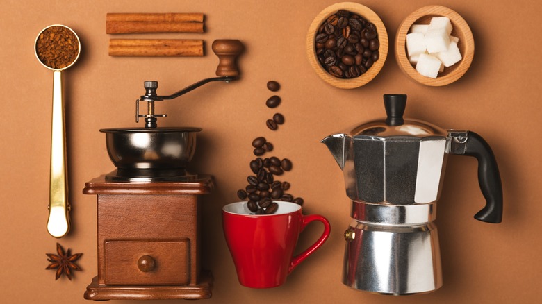 moka pot surrounded by coffee ingredients