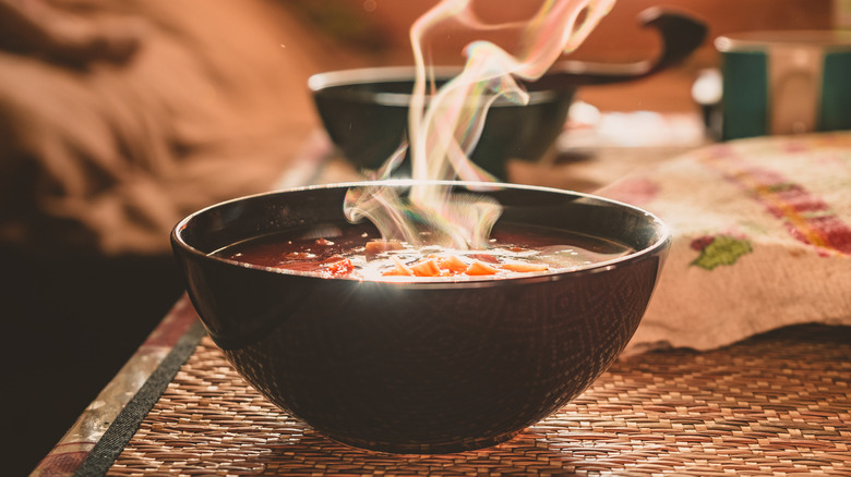 bowl of hot soup with steam rising up