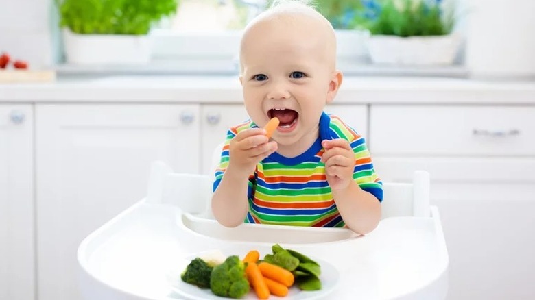 baby eating baby carrots