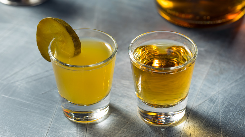 A pickleback shot with a glass of whiskey and Pickle juice