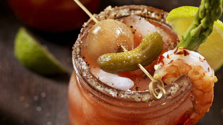 Seafood Bloody Mary garnished with a shrimp and gherkin