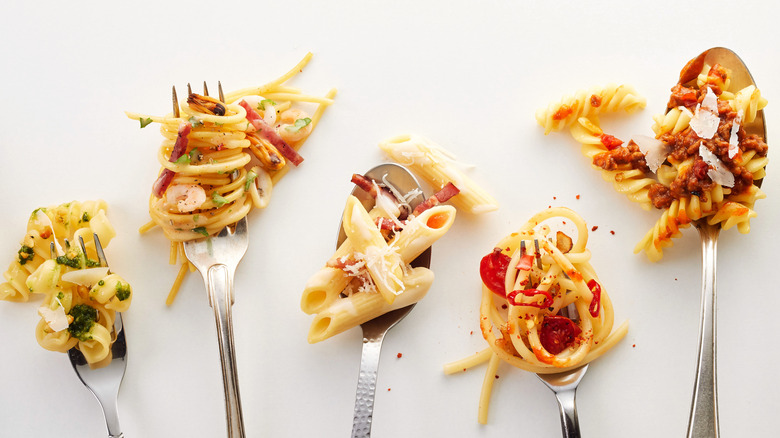 variety of pastas and sauces on utensils