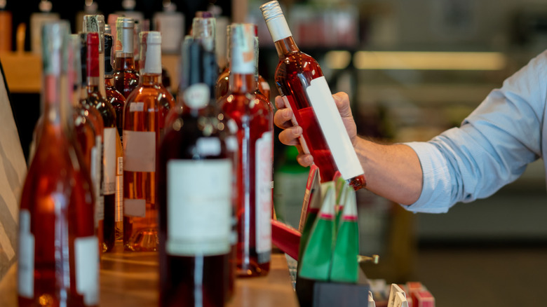 Hand holding a bottle of wine 