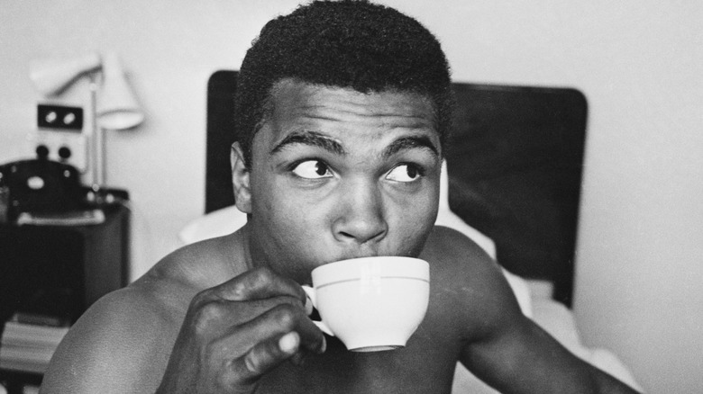 Muhammed Ali drinking tea with his pinkie finger raised