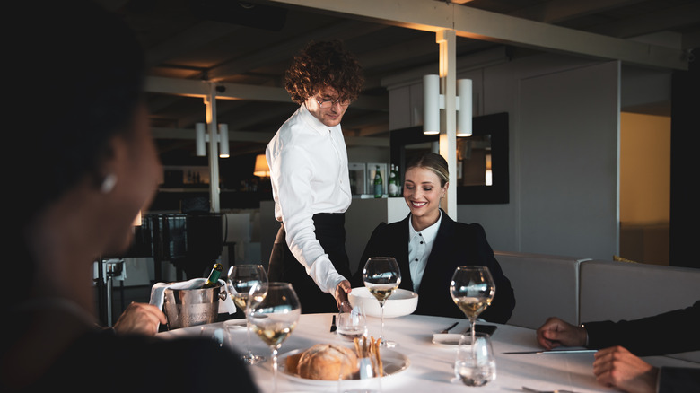 staff serving restaurant customer