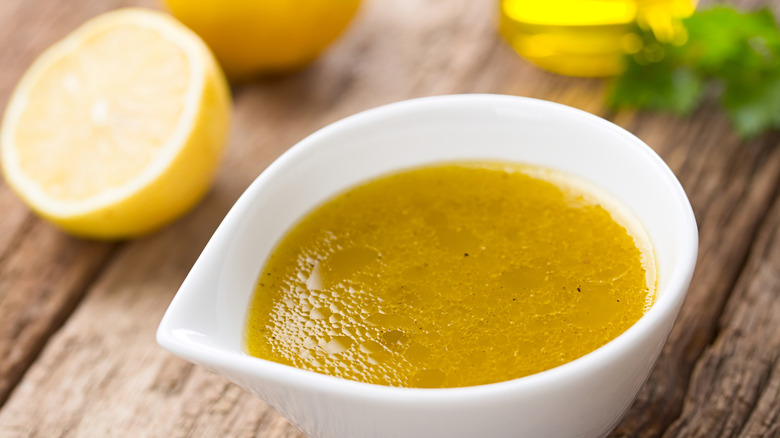 vinaigrette in a bowl with a lemon half