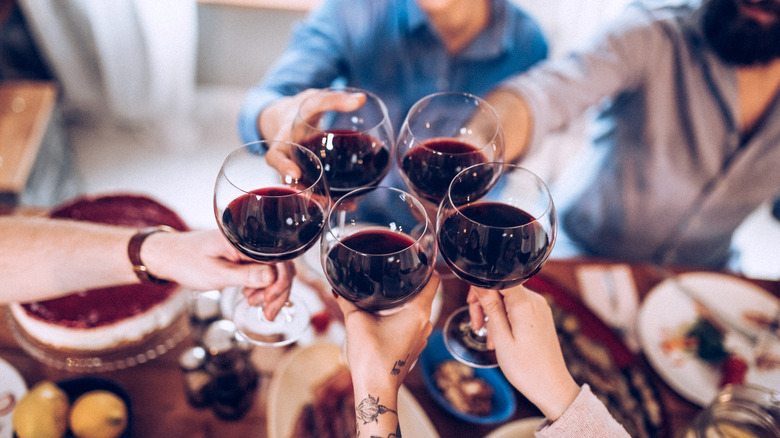 Wine glasses clinked together at table