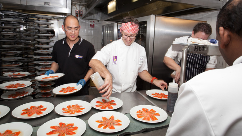 chef finishing dishes in kitchen