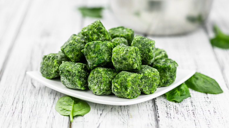 Frozen spinach cubes on white plate