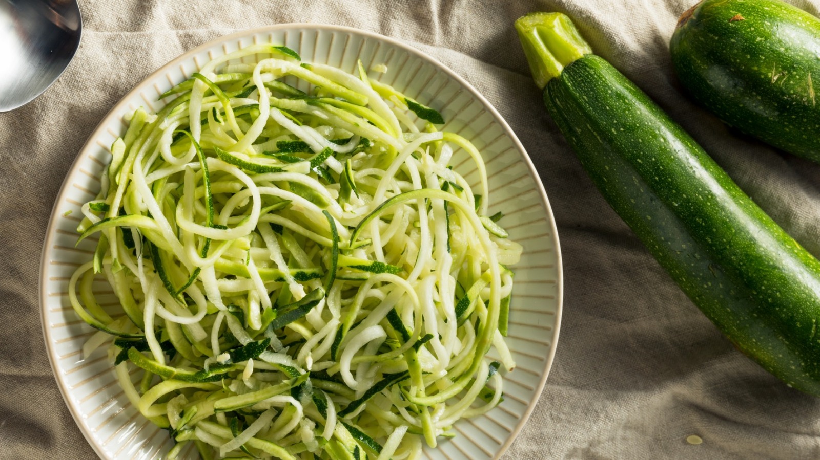 https://www.tastingtable.com/img/gallery/when-spiralizing-zoodles-choose-smaller-zucchini-for-less-watery-results/l-intro-1698758976.jpg