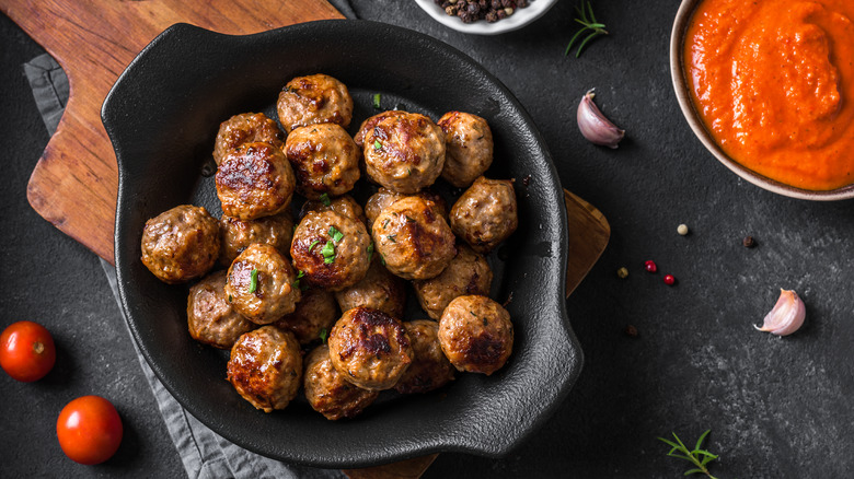 Top-down view of beef-roasted meatballs with herbal garnishing