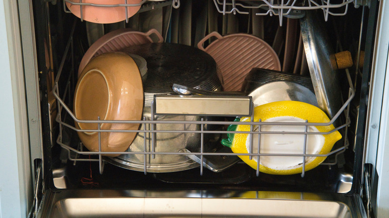 Dirty pans and tableware in dishwasher