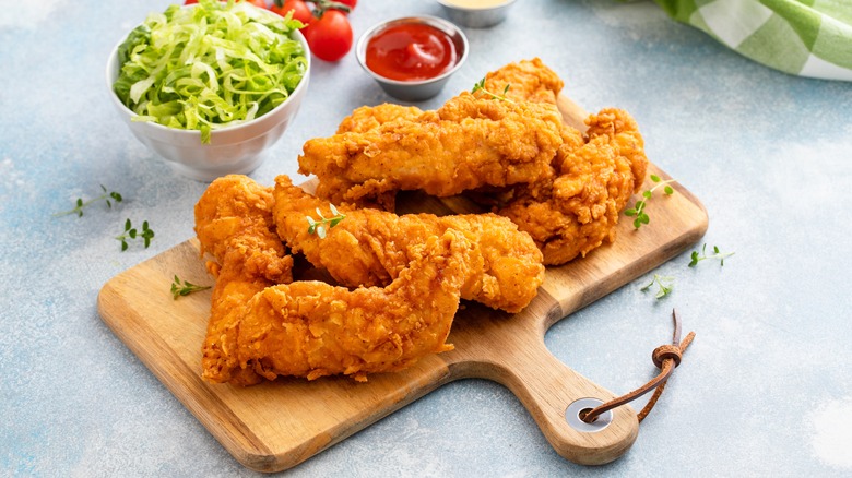 chicken tenders on wooden board