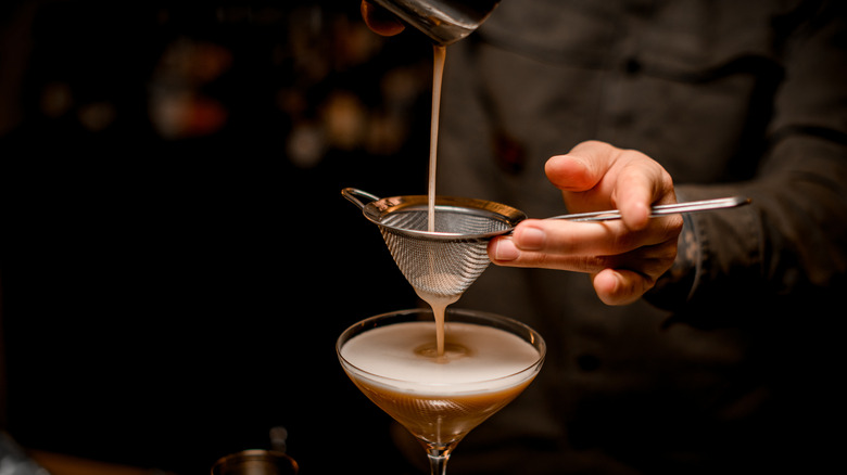 man pouring espresso martini