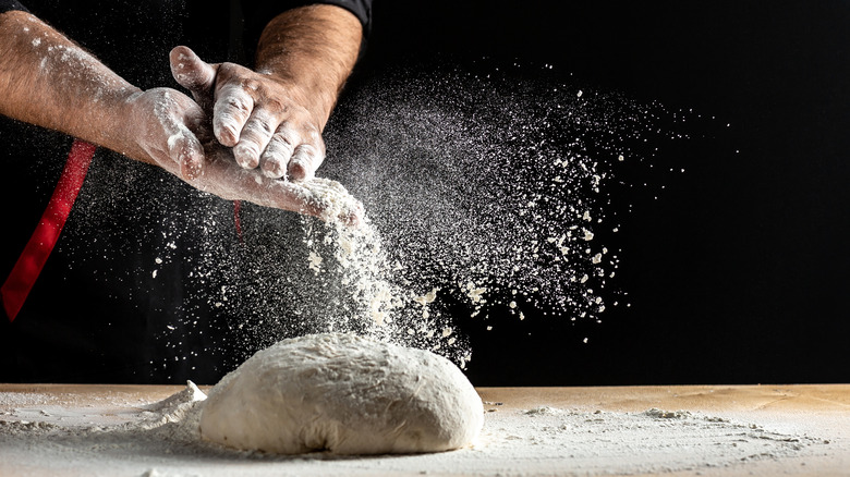 Flour covered hands and dough