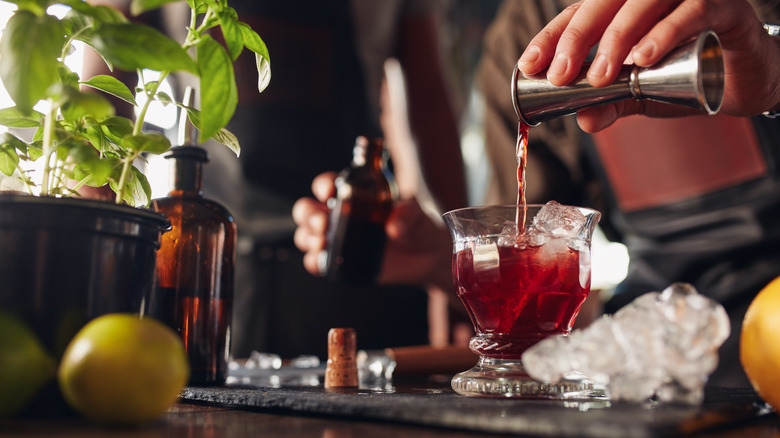 Bartender adding syrup to a cocktail