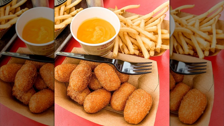 Casey's Corner corn dog nuggets and fries in separate trays with cup of cheese dip