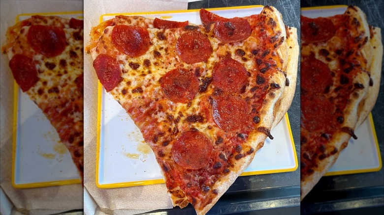 Two slices of Connections Eatery pepperoni pizza stacked on plate