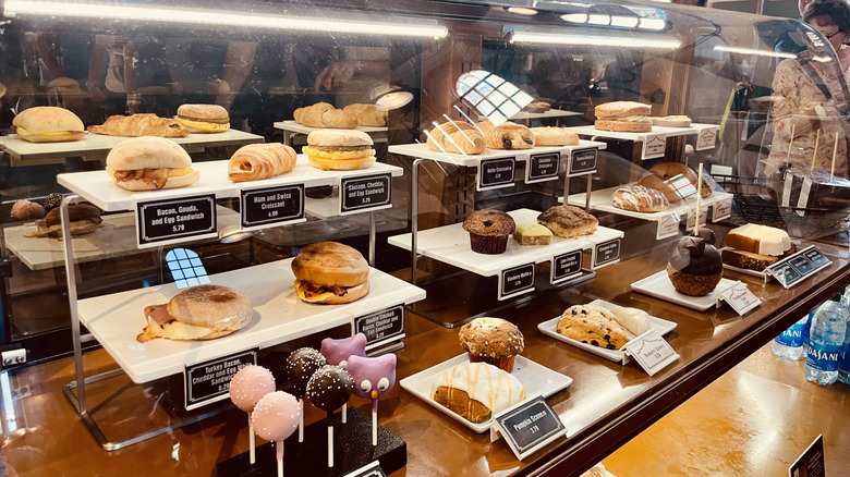 Pastry case full of treats like muffins, sandwiches, and carrot cake