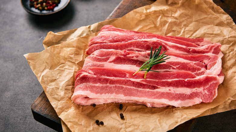 Raw pork belly sprawled out on paper