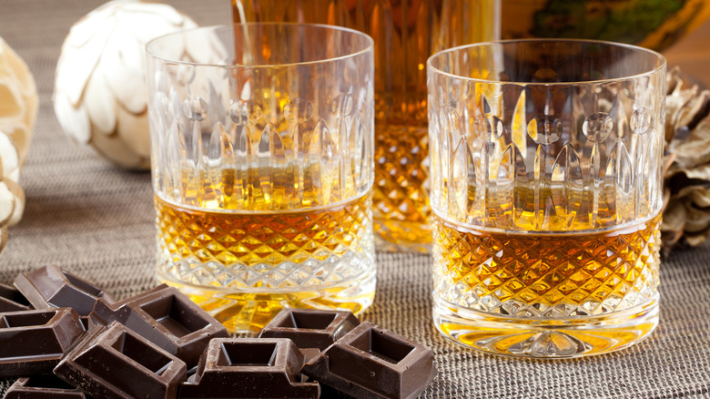 whiskey and chocolate bars on table