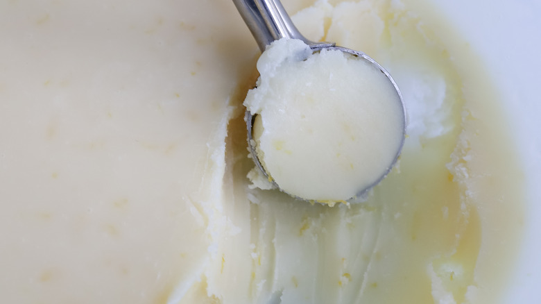 scooping white truffle mixture with cookie scoop