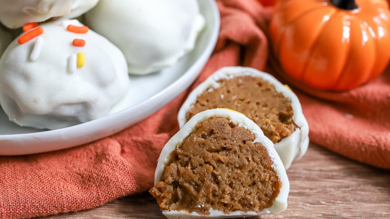 close up of a white chocolate pumpkin spice truffle cut in half