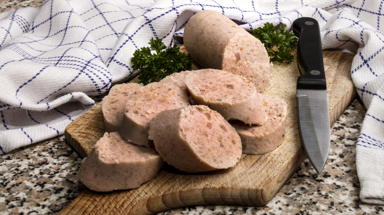 white pudding on wooden board with knife