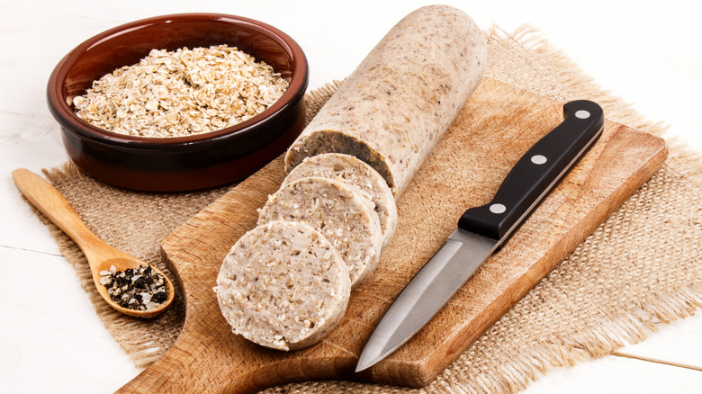 white pudding on board with bowl of oats