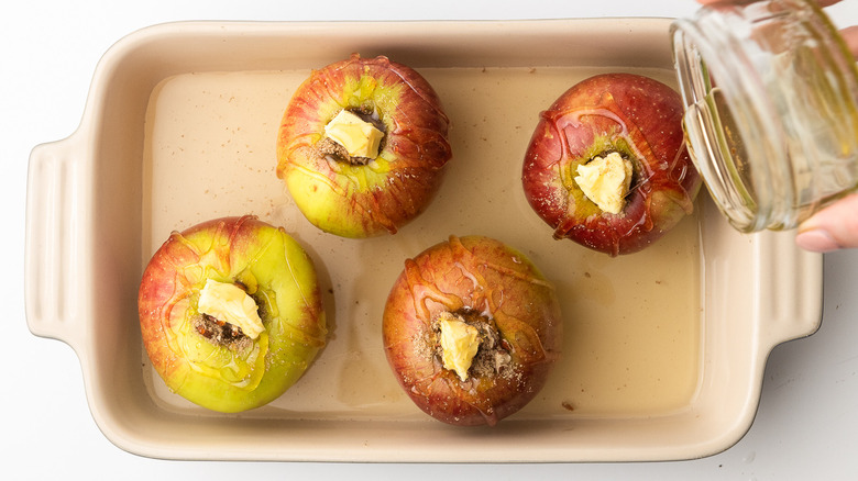 pouring honey on apples