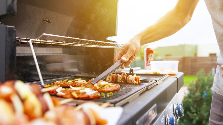 man grilling in sunny weather