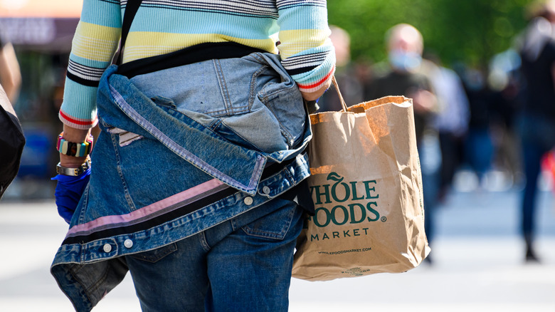 Whole foods bag, person from behind 