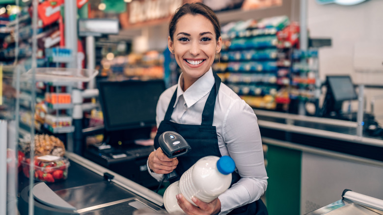 Grocery checkout clerk smiling