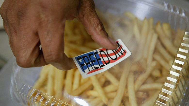 Canteen staffer pasting a freedom sticker on fries